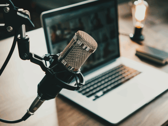 podcast microphone and laptop computer